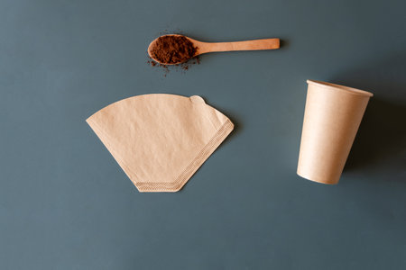 cup of coffee and Coffee filter used for american coffee machine  on green background with mockup spaceの写真素材