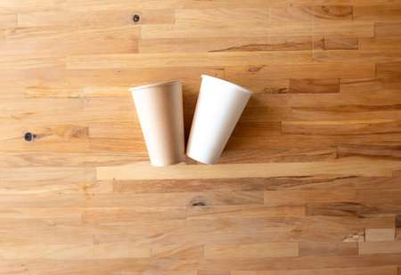 two paper cup of coffee on wooden background from top viewの写真素材