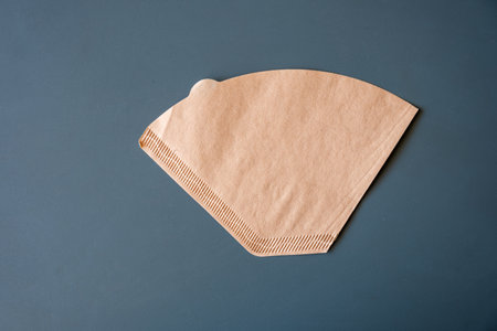 Coffee filter used for american coffee machine  on green background with mockup spaceの写真素材