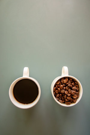 Coffee cups on green background  full of coffee beans and drinkの写真素材