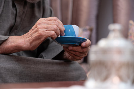 Old man drinking coffee with smile on his faceの写真素材