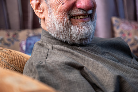 old man face smiling with bearded face in grey colorの写真素材