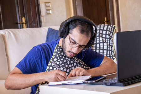 Young arabic man studying remotely