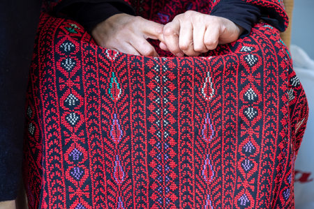 old lady hands wearing palestinian clothes feeling nervous about her relatives and familyの写真素材