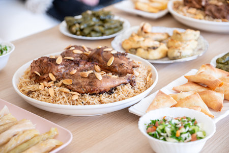 arabian dining table consist of rolls of cabbage rolls of grape , rice ,chicken, sambousek and qatayef without peopleの写真素材