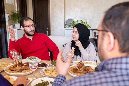 Family eating together with multi generation members in modern living roomの写真素材
