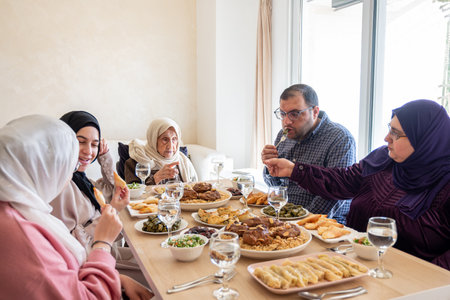 Family eating together with multi generation members in modern living roomの写真素材