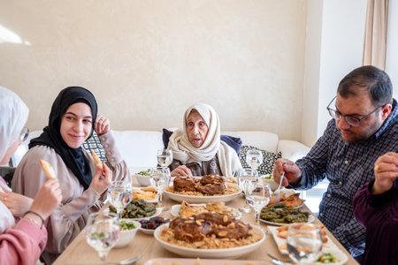 Family eating together with multi generation members in modern living roomの写真素材