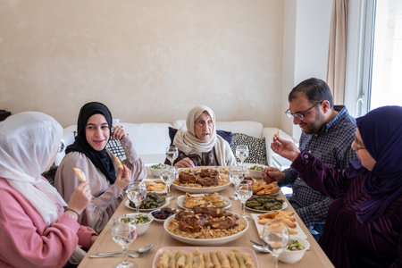 Family eating together with multi generation members in modern living room