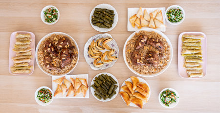 arabian dining table consist of rolls of cabbage rolls of grape , rice ,chicken, sambousek and...