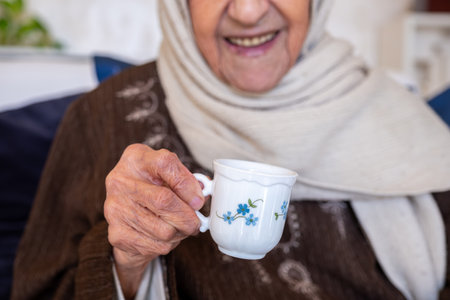Cheerful arabian old woman is offered a cup of coffee as a hospitality