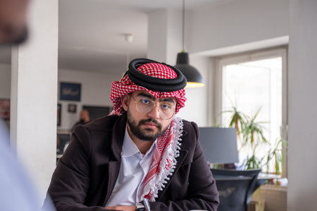 portrait for young arab male working in modern office with smile on his face