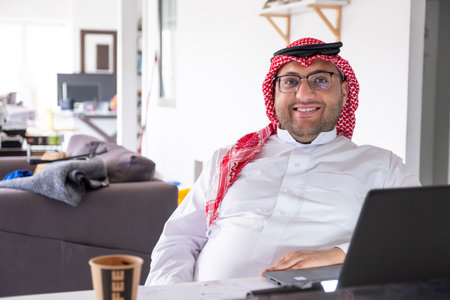 Portrait for mid age man using laptop to working from home while wearing his formal wearsの写真素材