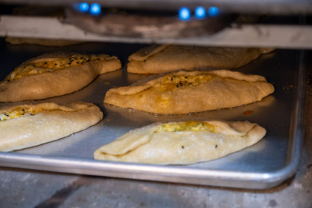 Pastries in oven being baked and freshly made of flour, olive oil and cheese, made according to jordan and palestine wayの写真素材