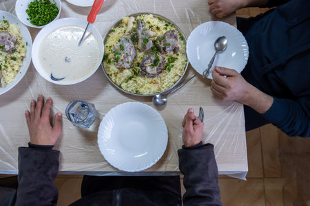 Family eating mansaf on dinner  for iftar