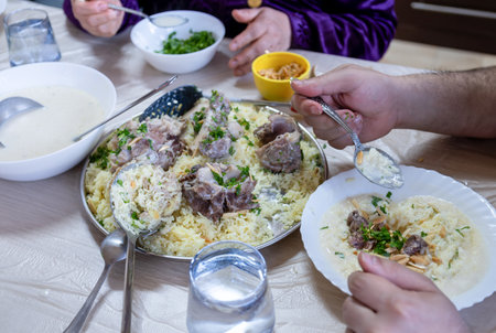 Family eating mansaf on dinner  for iftarの写真素材