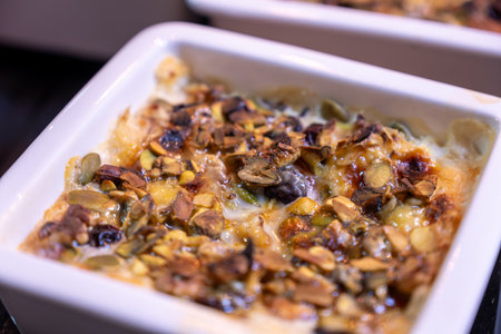 um ali is arabic sweet that made of puff pastry and nuts with milk and cream also you can add some honey as toppingの写真素材