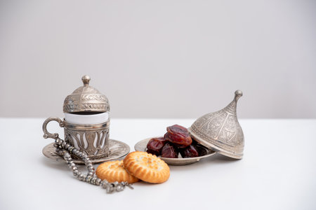 dates kahk eid sweets rosary and coffee cups on white isolated background