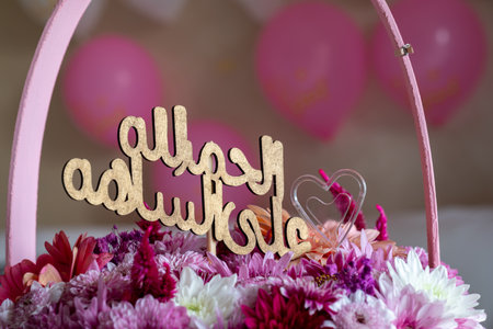 Pink Bouquet with heart shape and multi colors and balloons in the background as decoration for celebrationの写真素材