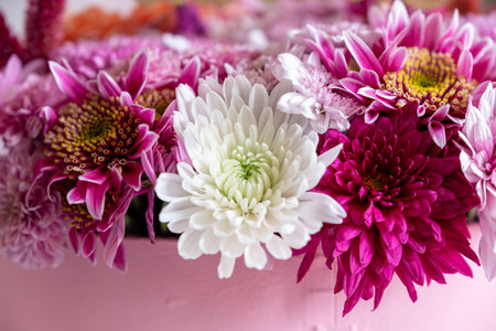 Pink Bouquet with heart shape and multi colors and balloons in the background as decoration for celebrationの写真素材