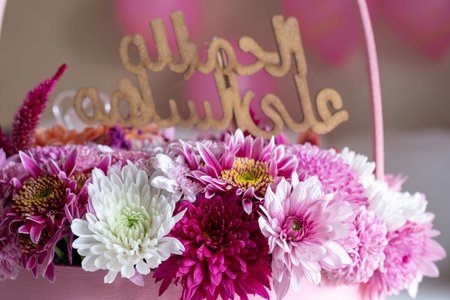 Pink Bouquet with heart shape and multi colors and balloons in the background as decoration for celebrationの写真素材