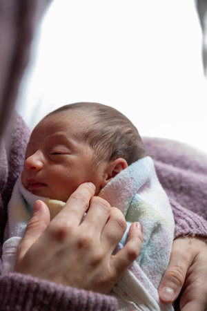 mother looking at her newborn with love