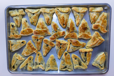 baked stuffed pastries on black marble background ready to be served and moved from tray to bowls on dinner table or in school kids back bagの写真素材
