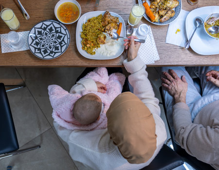 Top view of mother and baby having dinner while paying attention to her newbornの写真素材
