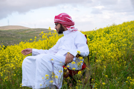 Wellness in nature for arab male between yellow flowersの写真素材