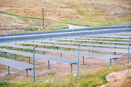 PV panels are used to generate electricity outdoors on green land with street beside