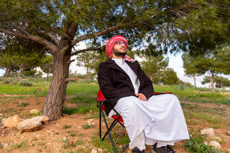 An individual sits in a golden field of roses at sunrise, arms raised in positivity. The fresh spring air and vibrant sky symbolize health and freedom capturing a moment of harmony and adventureの写真素材