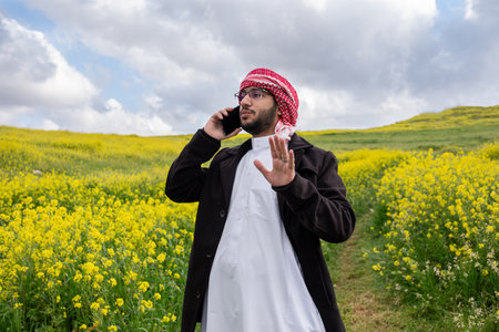 young arabic male making phone call during vacation, working from anywhere and stay connectedの写真素材