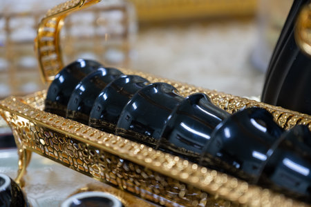 Black glossy coffee set on metallic and gold tray ready for serving during holidays and family...