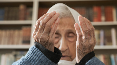 Old muslim woman praying for god to bless her and give her strength