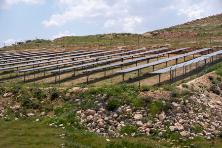 Solar farm with tracking system to maximise the energy absorbed from sun build on hill  to be in the...