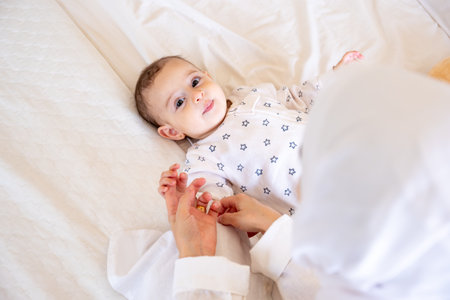 Cute Funny Little white Baby Having Fun While Lying On Bed At Home, Infant girl Playing With here...