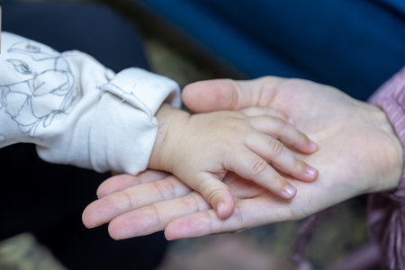 Close up of three caucasian person stack their palms. Grandmother mother and granddaughter holding their hands together. Gesture sign of support and love, unity togetherness relative people conceptの写真素材