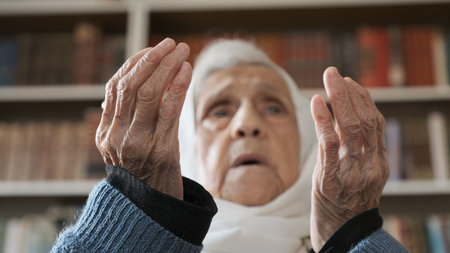 Old muslim woman praying for god to bless her and give her strengthの写真素材