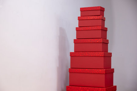 red gift boxes with different sizes for valentine and love presents during holidays and celebrationsの写真素材