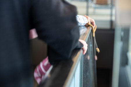 Female using an escalator while holding its handle.の写真素材
