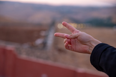 Female hand doing victory sign gestureの写真素材
