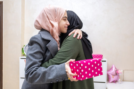 muslim Daughter hugging and gifting her motherの写真素材