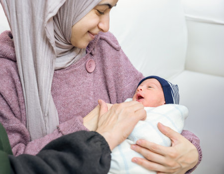 Mother daughter and baby, multigenerational family on white background feeling happyの写真素材