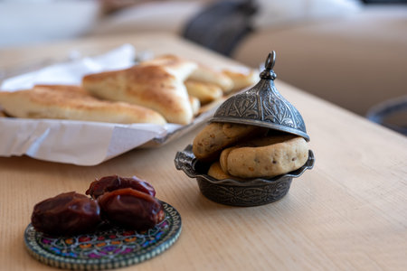 Stuffed pastries with eid sweets on wooden table as ramadan sweets for iftarの写真素材