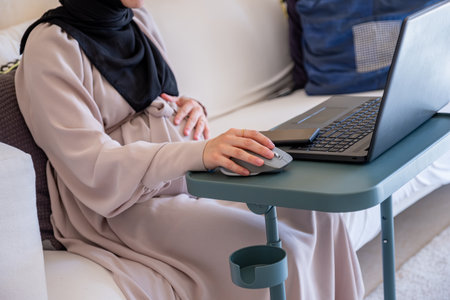 Pregnant woman working from home checking internet about pregnancy and have doctors advice through...