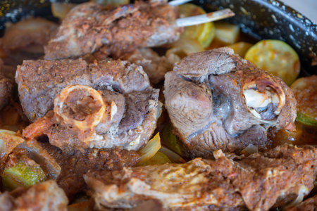 Meat vegetables tray  cooked in oven on wooden background  with mock up spaceの写真素材