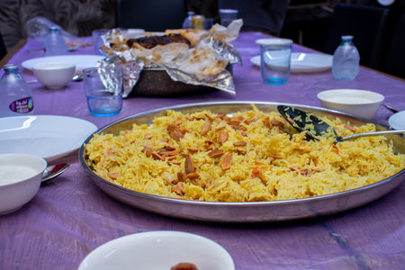Rice topped with almonds ready to be eaten on table