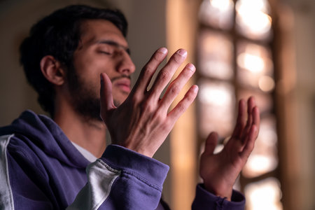 muslim male rising his hands to pray for allah and asking for forgiveness and helpの写真素材