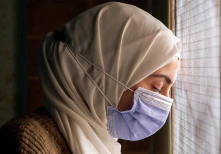 Muslim woman wearing mask and praying to protect her from diseasesの写真素材