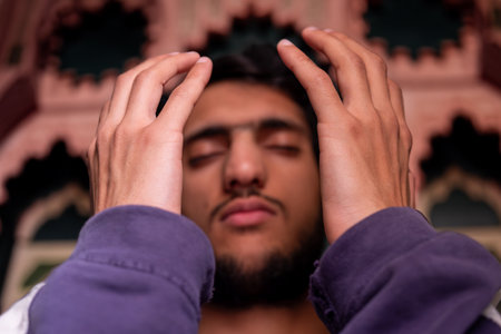 muslim male rising his hands to pray and asking for forgiveness and helpの写真素材